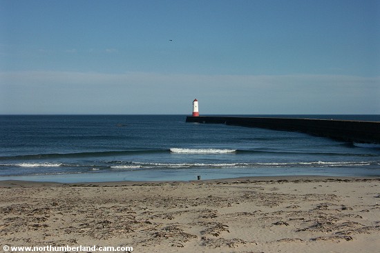View from the beach to the pier and lighthouse.