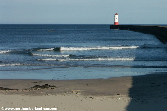 View from the beach to the pier and lighthouse.