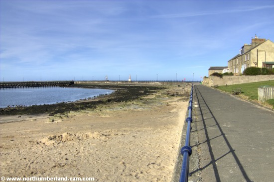 View of the small beach in Amble beside the harbour.