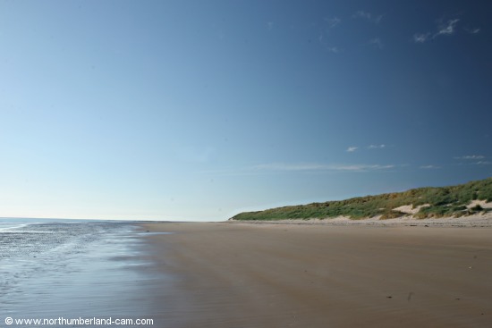 Early summer morning view of Bamburgh Beach.