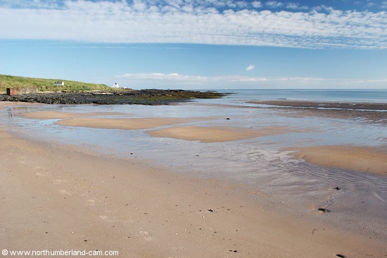 Early summer morning view of Bamburgh Beach and Lighthouse.