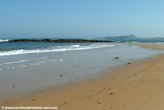 View south along the beach to Dunstanburgh Castle.