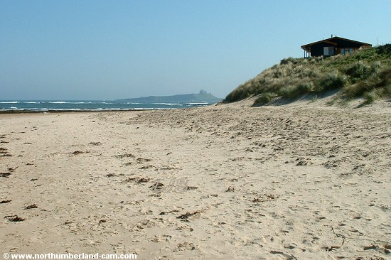 View at the south end of the beach with holiday homes on the dunes above.